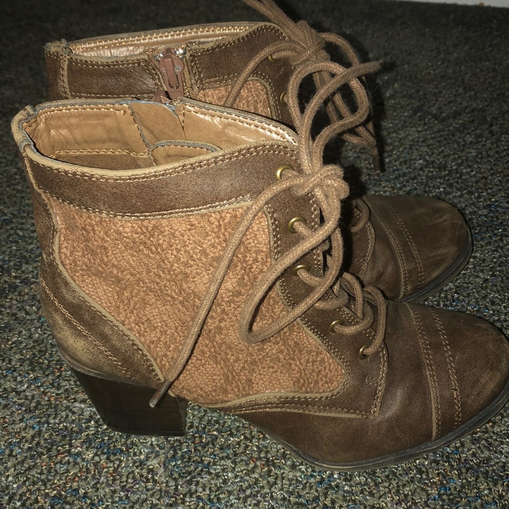 Brown heeled boots with lacing on the side